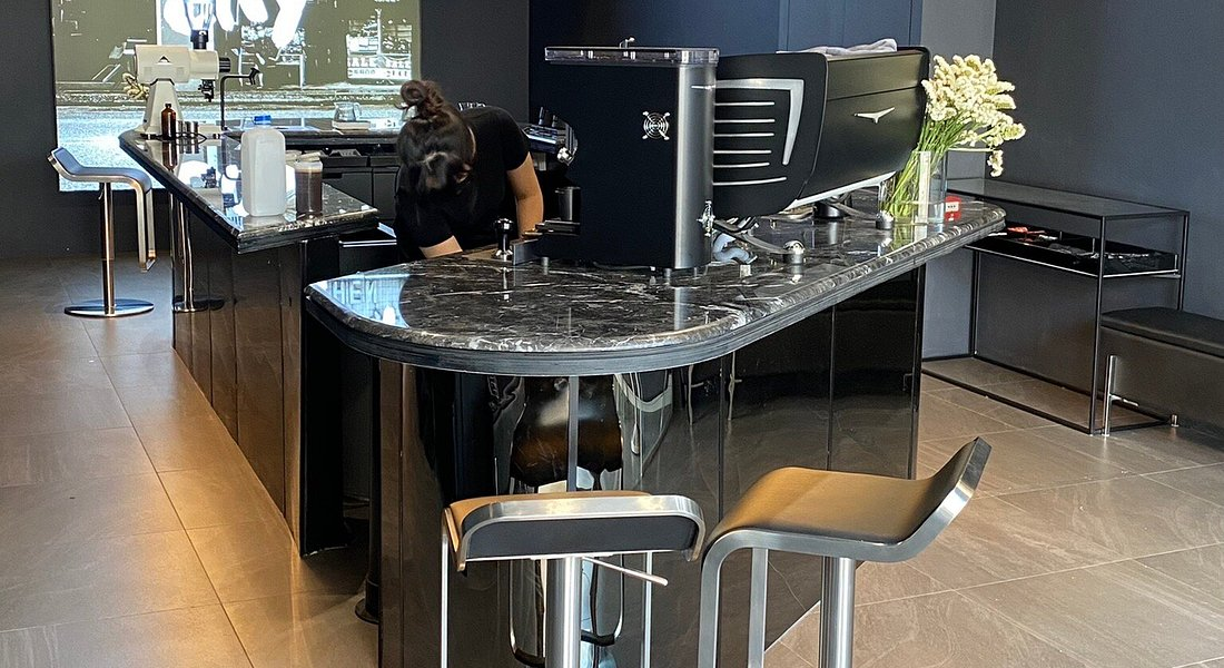 Black marble bar counter and espresso machine setup